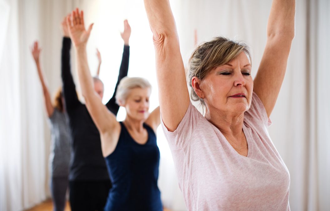 Group of people doing yoga exercise.